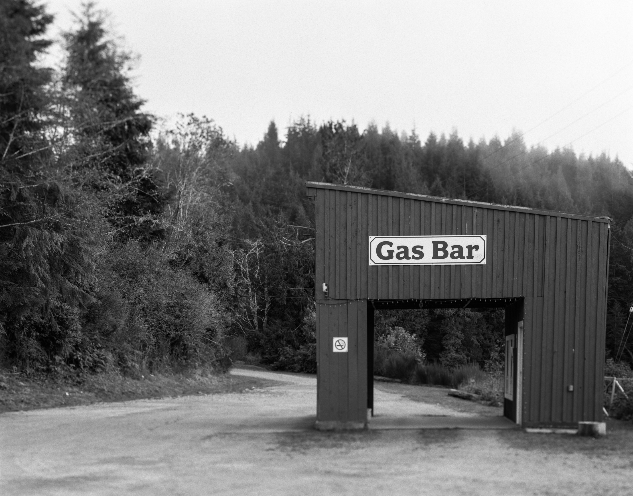 The local gas bar in Bamfield reflected in calm water at dusk